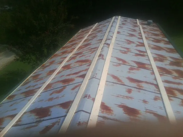 Rusted metal roof panels with new wood purlins before replacement — Storm Damage Roof Repair in Alsip by Roofing Brothers