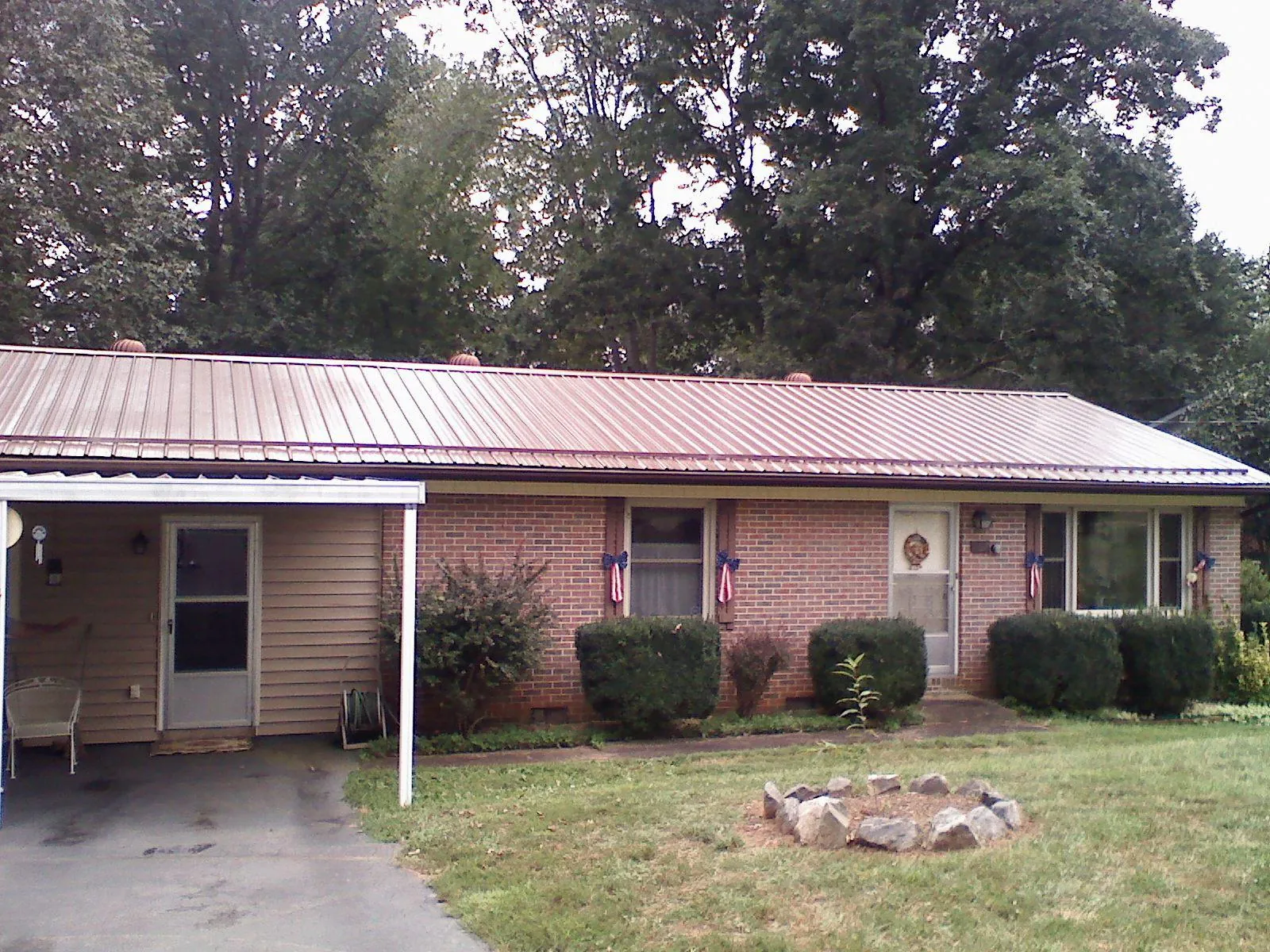 Bronze metal roof and carport on a brick ranch home — Roof Repair work by our crew in Alsip